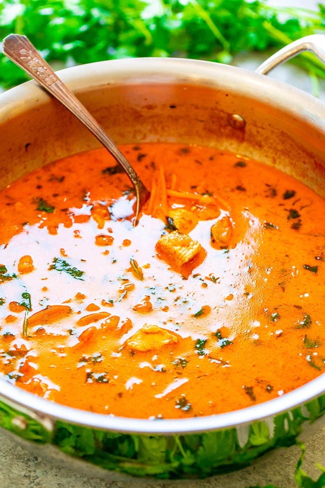 Thai Chicken Coconut Curry Soup in a pot with a ladle sticking out. Thai Chicken Coconut Curry Soup in a pot with a ladle sticking out.