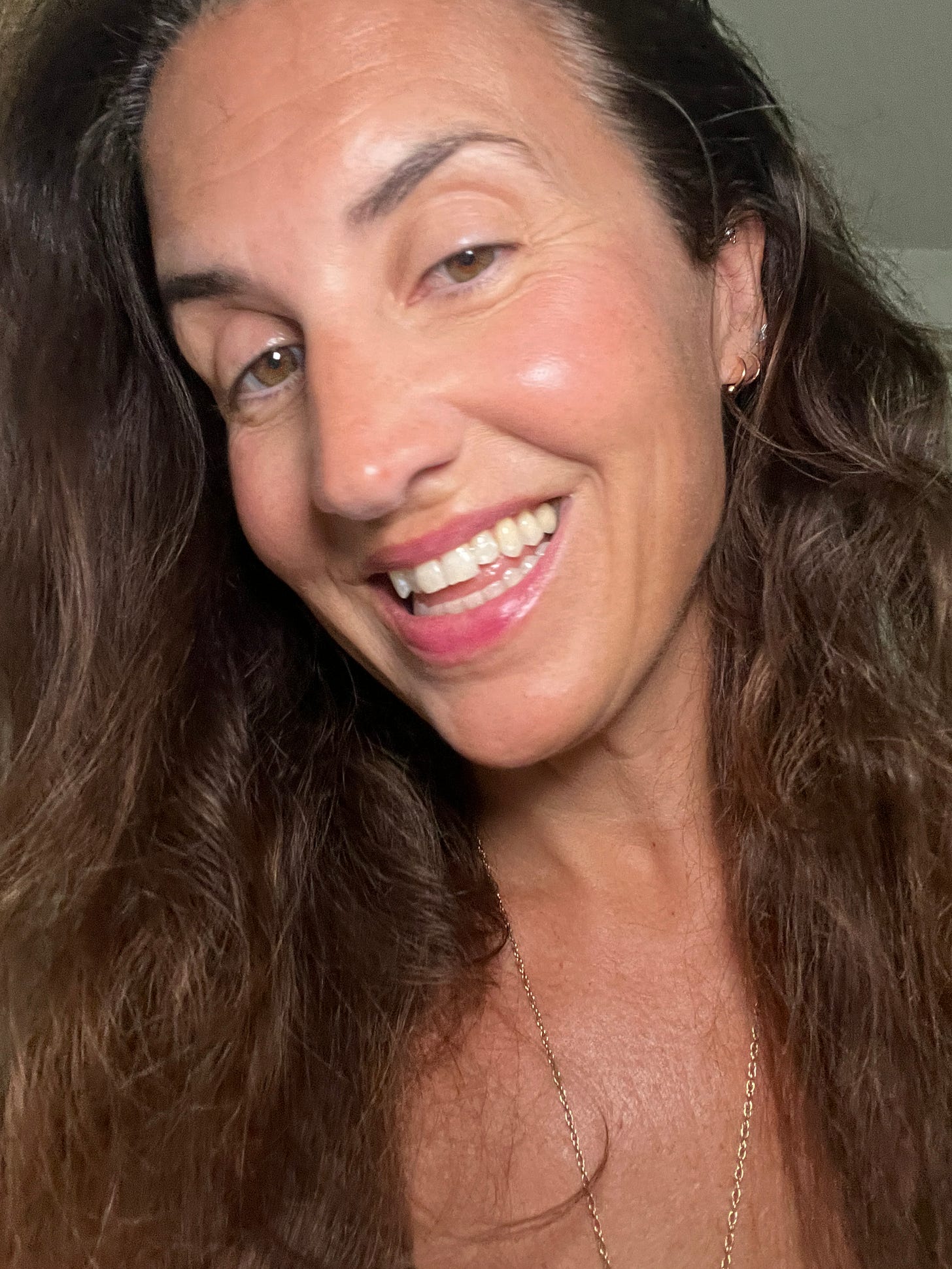Beauty Editor Donna Francis wearing the $5 e.l.f. Sheer For It Blush Tint in the shade So Petal on her cheeks and lips, showing a natural, water-based finish.