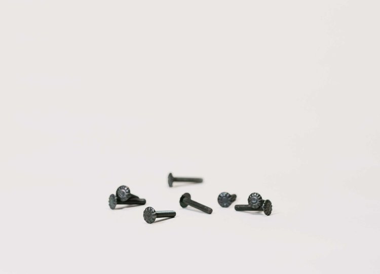 Eight 200a speaker screws on a white background