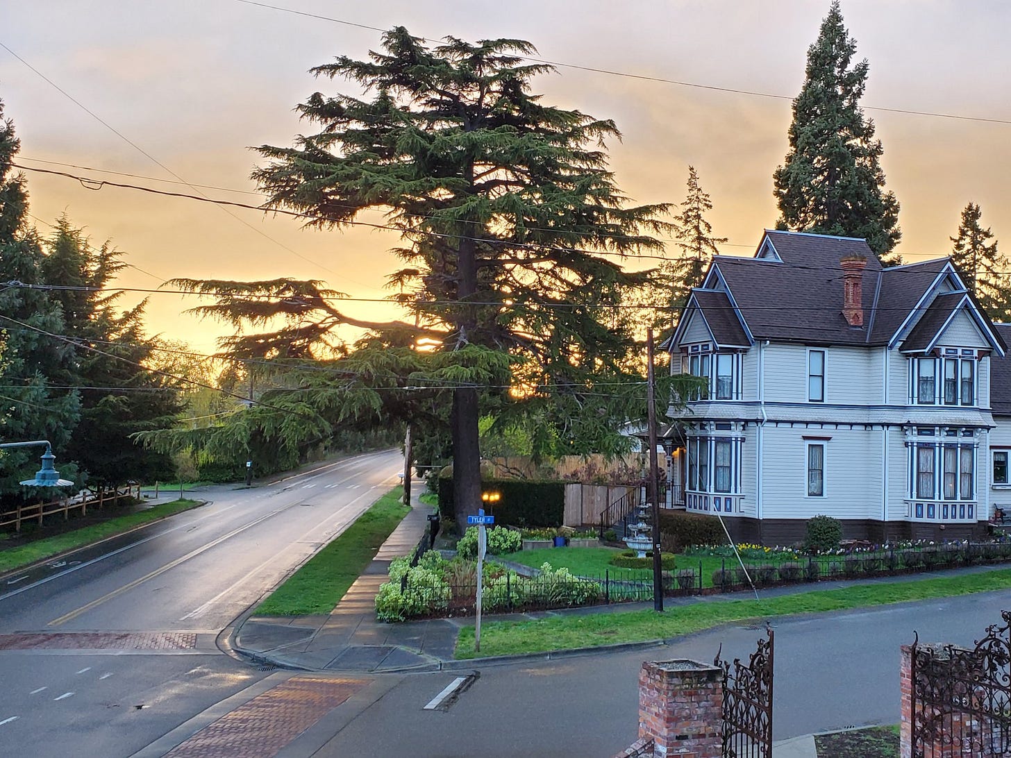 A street view in Uptown Port Townsend. The sun sets behind the Stockand House at the corner of Tyler and F streets.