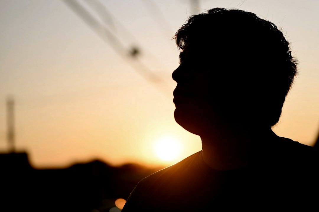 Man silhouetted against a setting sun
