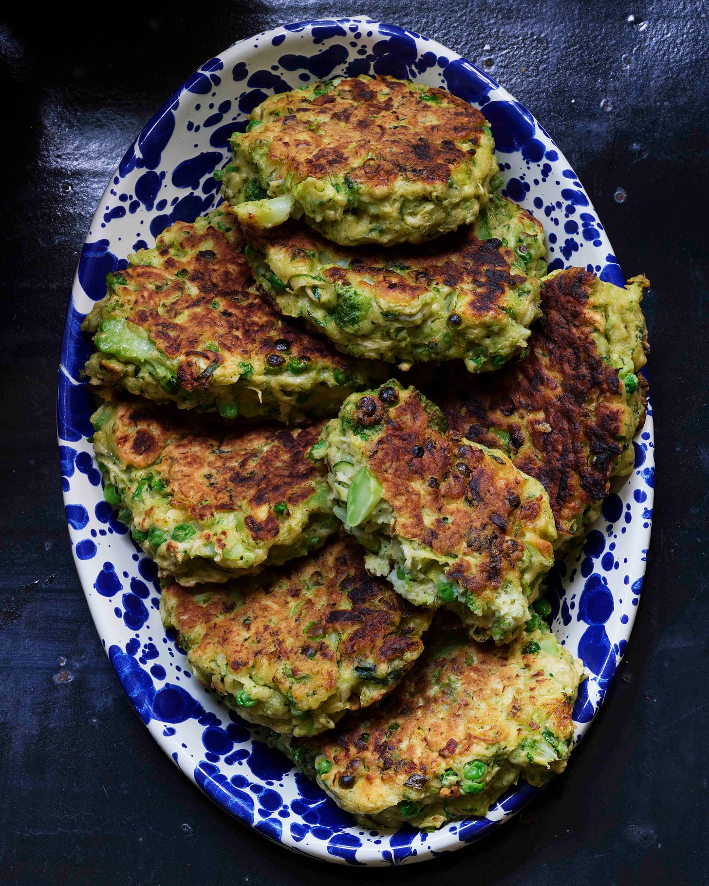 Broccoli hotcakes vegetable pancakes on an enamel plate. Broccoli hotcakes vegetable pancakes on an enamel plate.