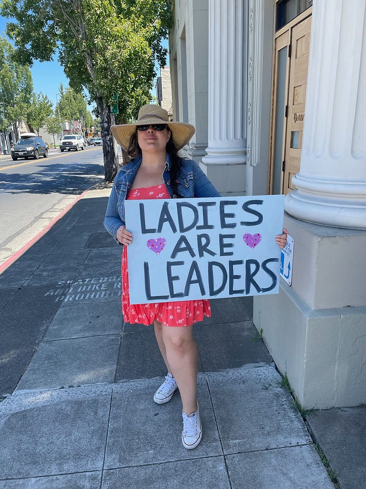 Woman with posters supporting Kamala Harris for President