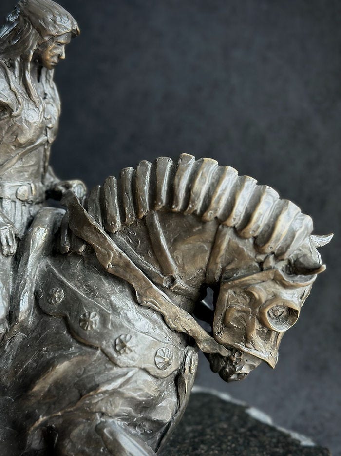 Spirit Warrior, cast bronze sculpture of a warrior woman riding her warhorse by Kindrie Grove