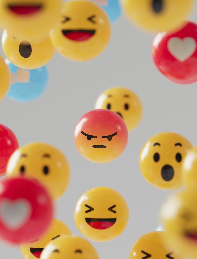 Illustration of 3D emojis with the 'angry' emoji in the centre of the image.