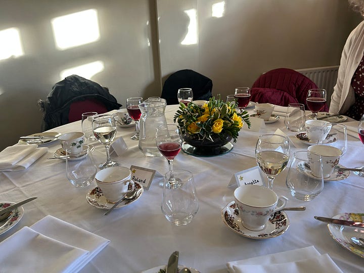 Cakes on a cakestand and a table laid out for guests at Petwood Hotel, Woodhall Spa
