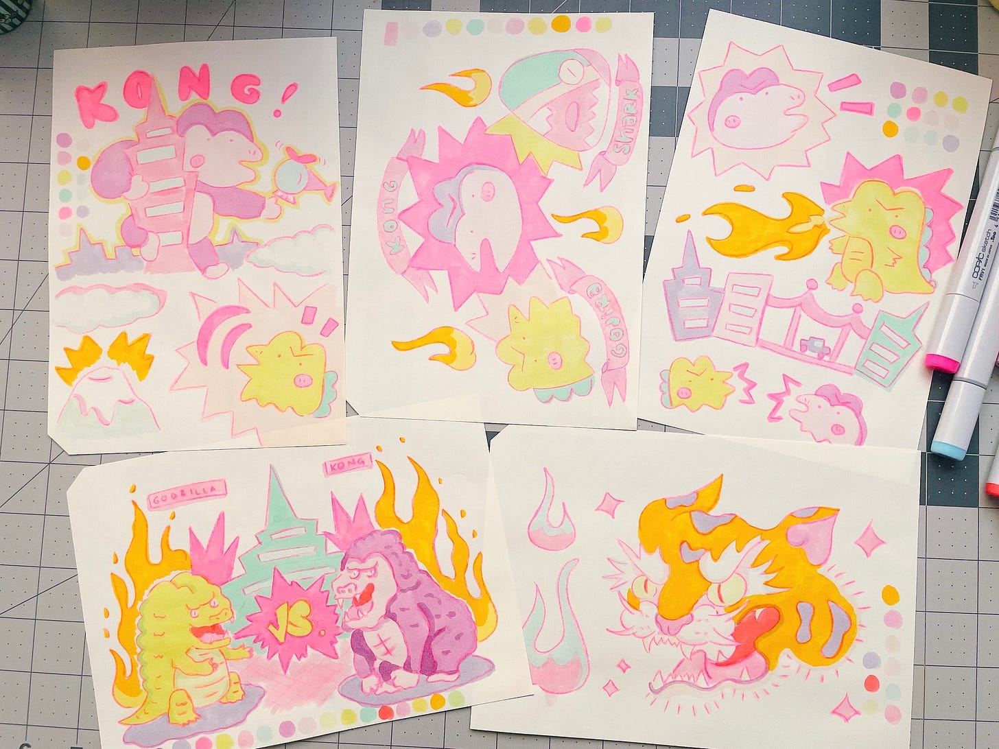 A photo of five marker illustrations featuring Godzilla, King Kong, sharks, and tigers in bright and pastel colors.