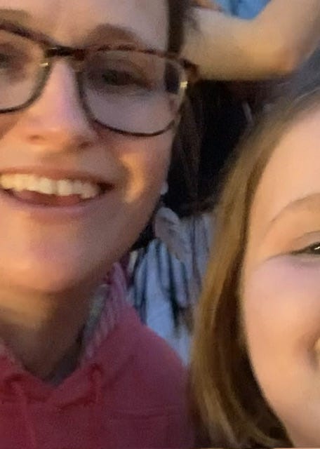 Closeup of the author and her child singing along