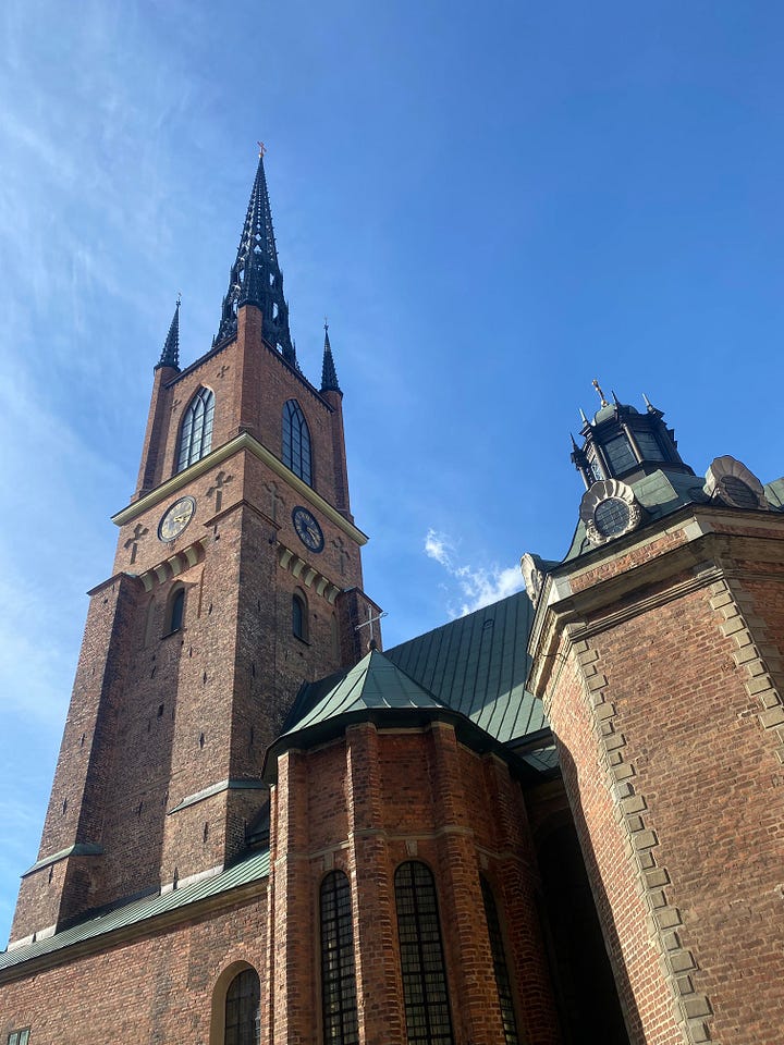Charming church and mulit-colored row houses in historic Stockholm.