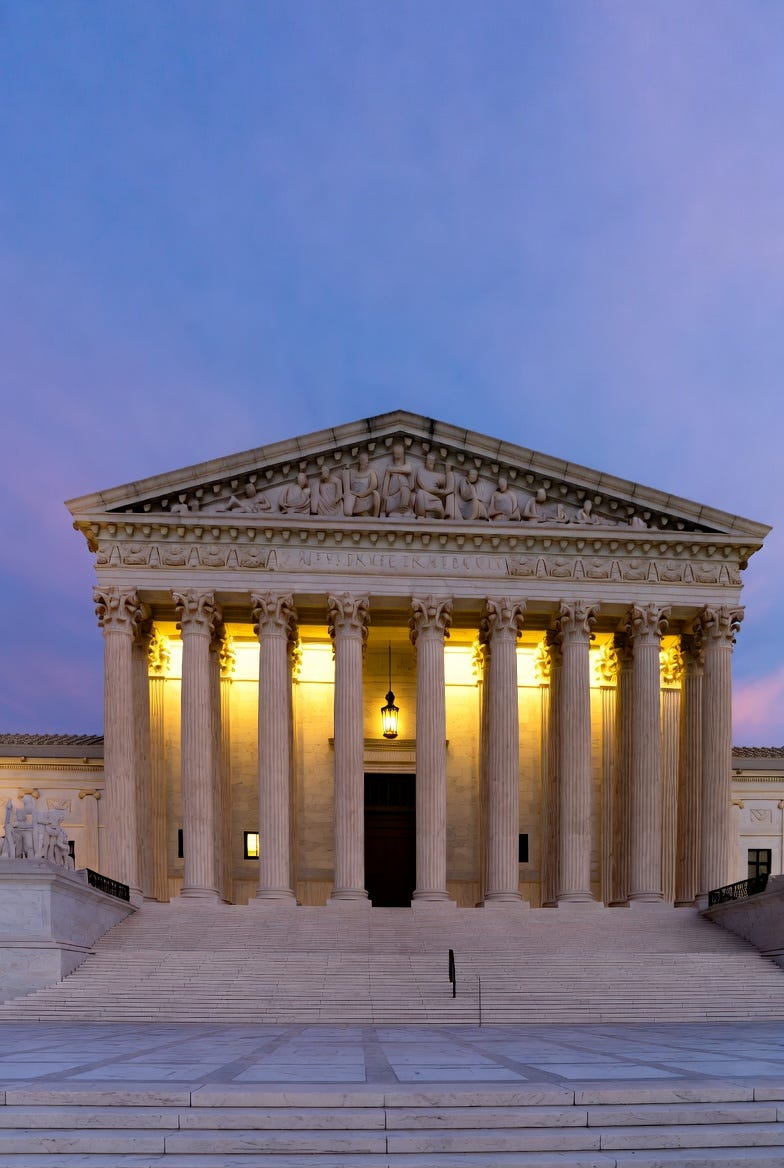 A photograph of the United States Supreme Court building at dusk, featuring neoclassical architecture and twilight lighting. A photograph of the United States Supreme Court building at dusk, featuring neoclassical architecture and twilight lighting.