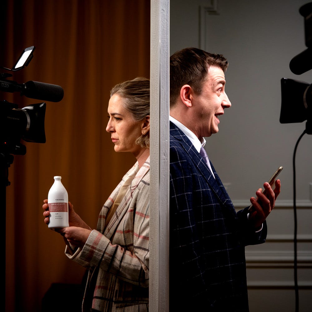A split view of two TV studios, one with a somber woman holding a white bottle, the other with a jolly man holding a mobile phone.