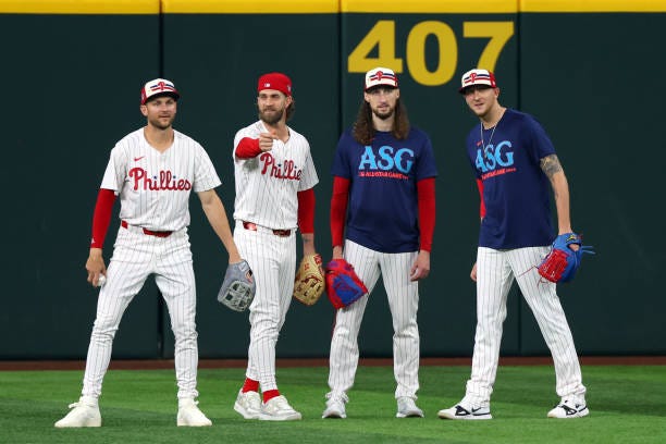 Trea Turner, Bryce Harper, Matt Strahm and Jeff Hoffman of the Philadelphia Phillies look on from the outfield during Gatorade All-Star Workout Day...