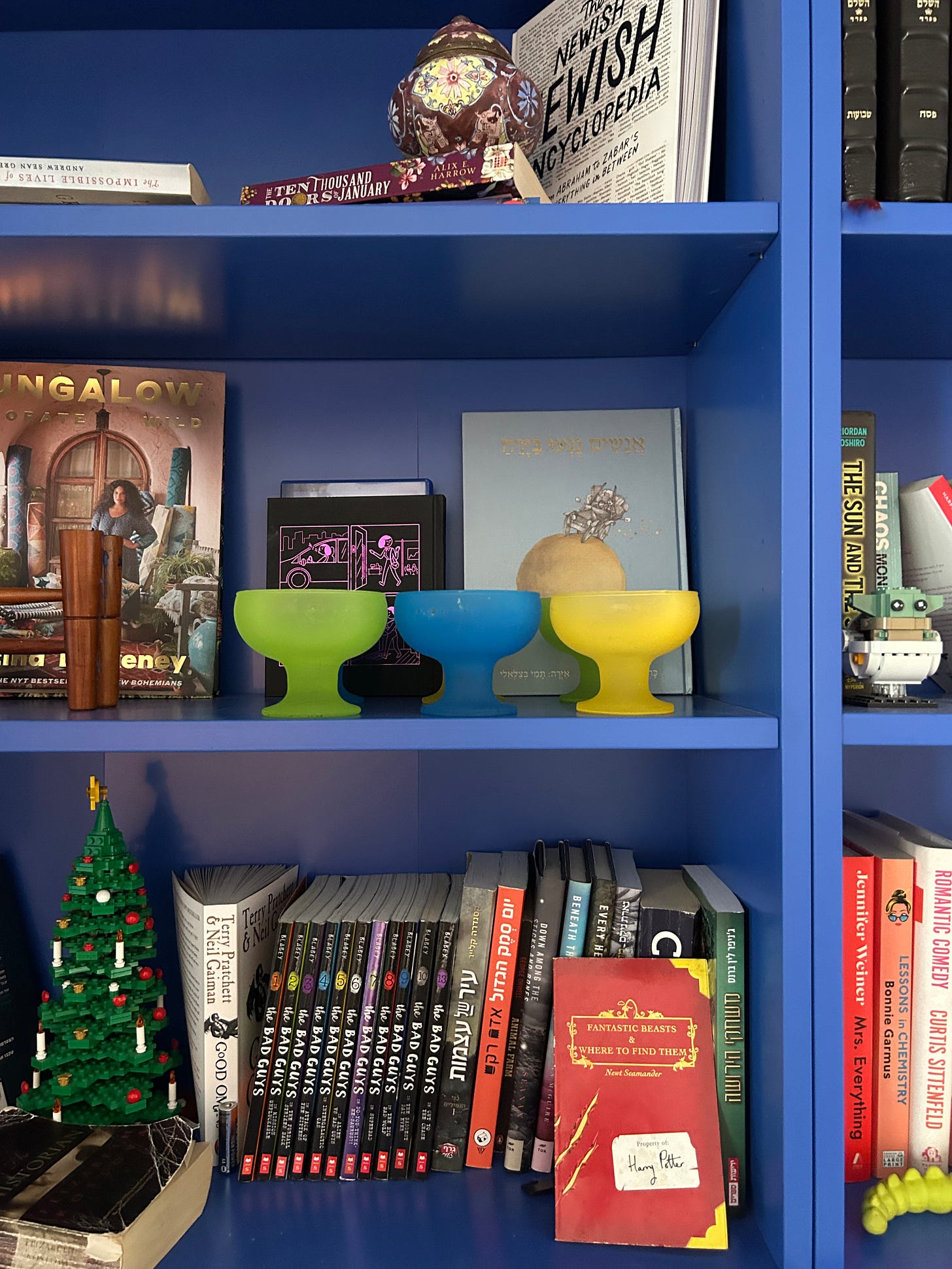 colorful dessert dishes displayed on cobalt blue shelving
