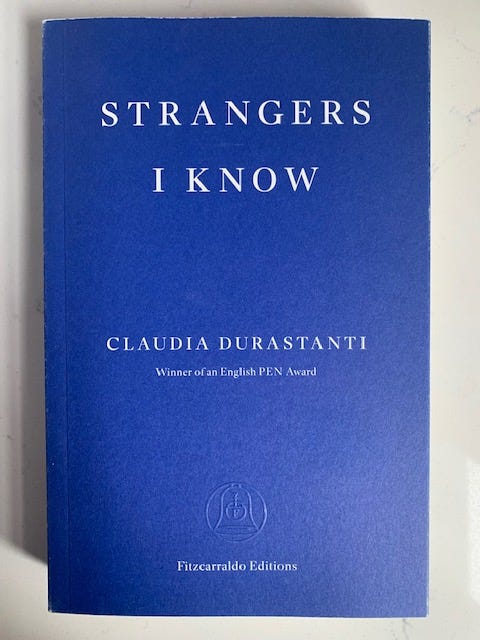 The book cover is blue with white letters and says strangers I know by Claudia Durastanti