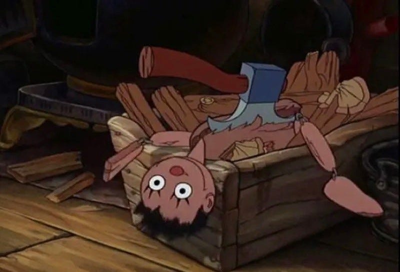 screenshot from 'Pinocchio' (1940) showing a wooden marionette in a firewood box, its chest split by an axe.