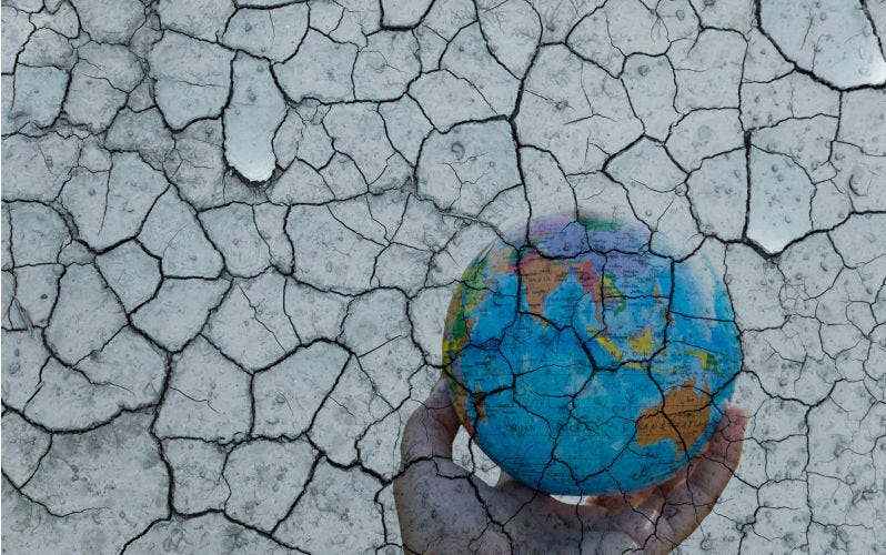 blue earth or world model on human hand with soil crack in environmental.