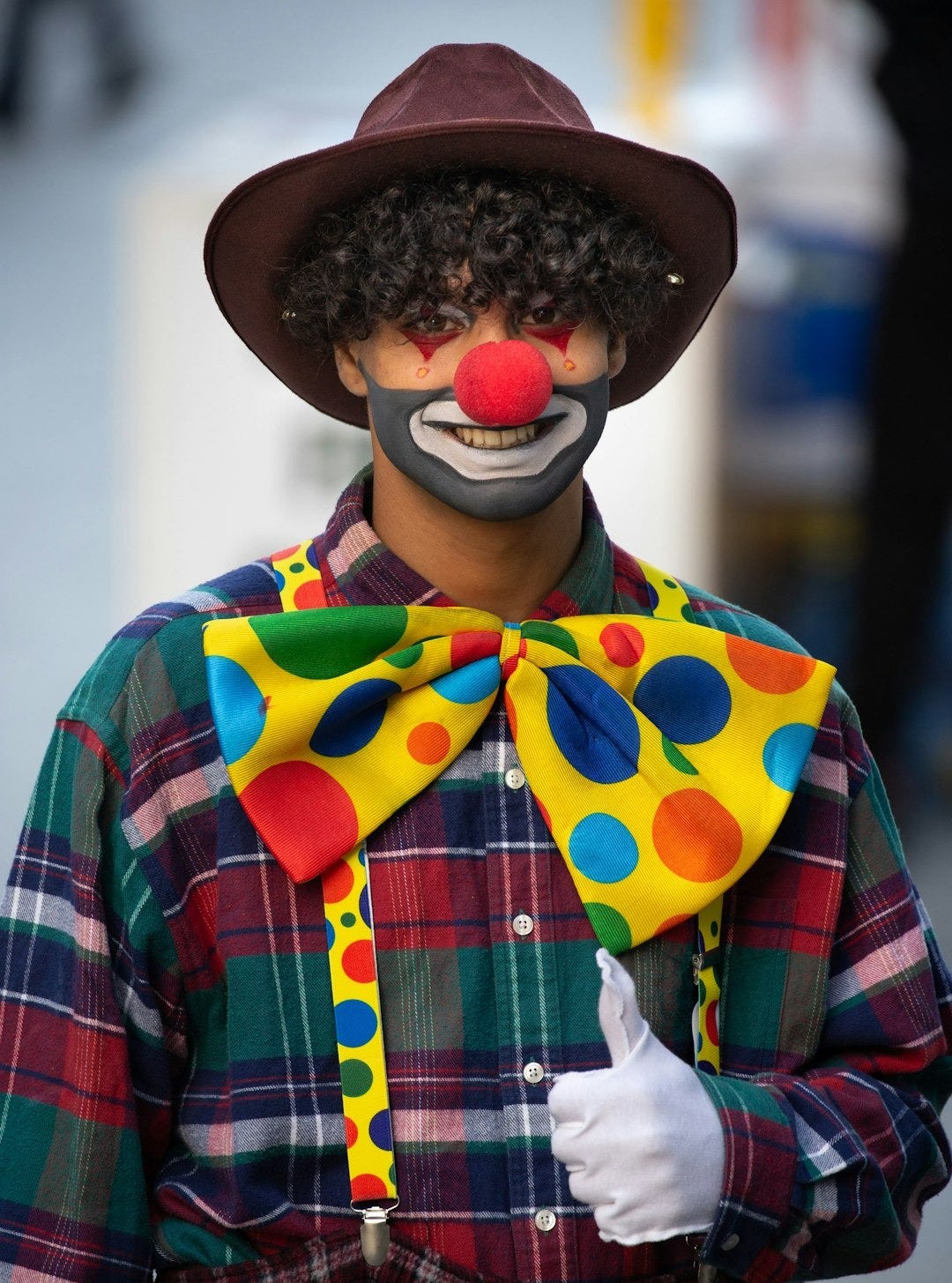 man in blue red and white plaid button up shirt wearing brown hat