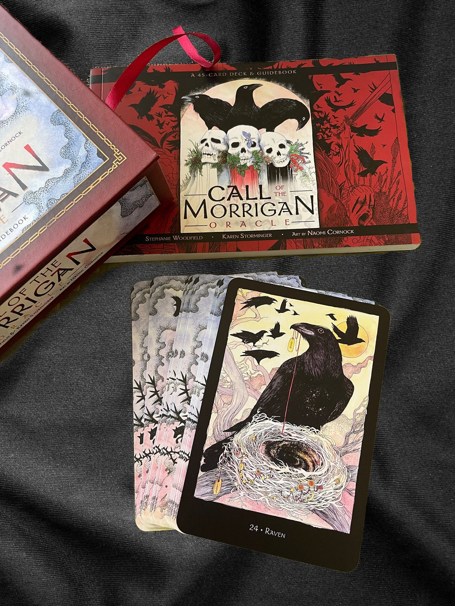 Call of the Morgan Oracle deck shows guidebook, corner of box and raven card. 
