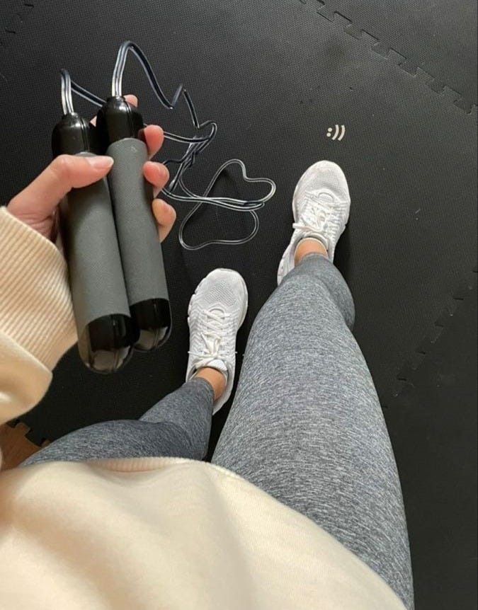 This may contain: a person is holding a pair of scissors and an object in front of their feet