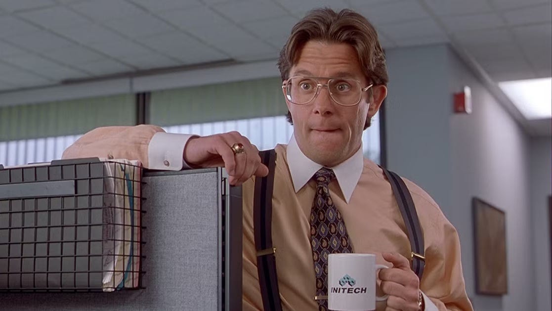 Iconic image of the awful boss in 'Office Space,' one arm draped over the top of a cubicle, the other hand holding a coffee mug. His lips are pursed, either in an expression of disappointment, or maybe just saying the 'P' in 'TPS reports,' we didn't check the video. Iconic image of the awful boss in 'Office Space,' one arm draped over the top of a cubicle, the other hand holding a coffee mug. His lips are pursed, either in an expression of disappointment, or maybe just saying the 'P' in 'TPS reports,' we didn't check the video.