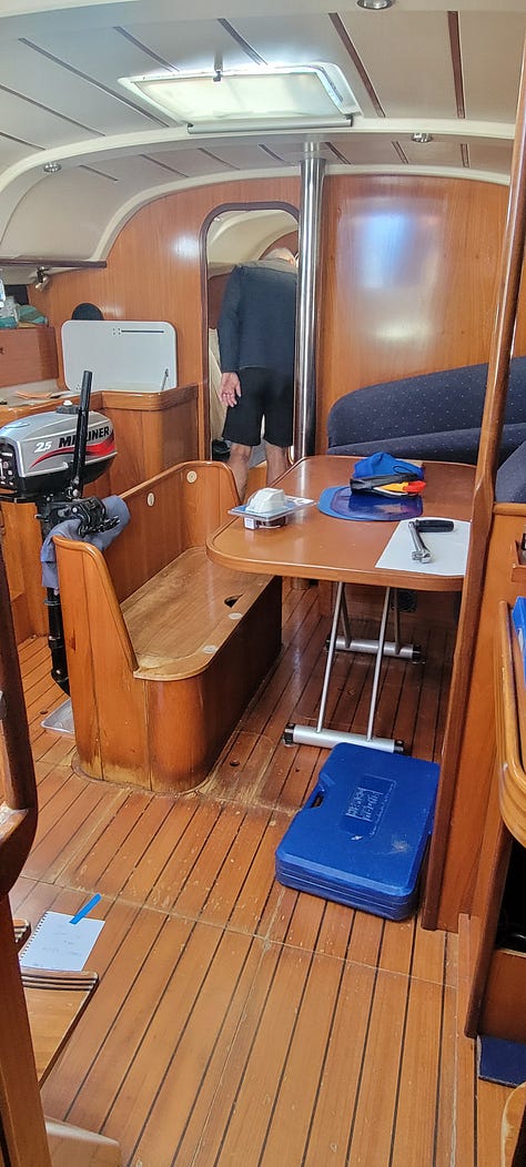 3 pictures of the interior and exterior of a monohull. There is visible water damage on the floor of the salon.