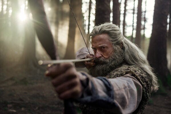 This image released by A24 shows Hugh Jackman in a scene from "The Death of Robin Hood." (Aidan Monaghan/A24 via AP)