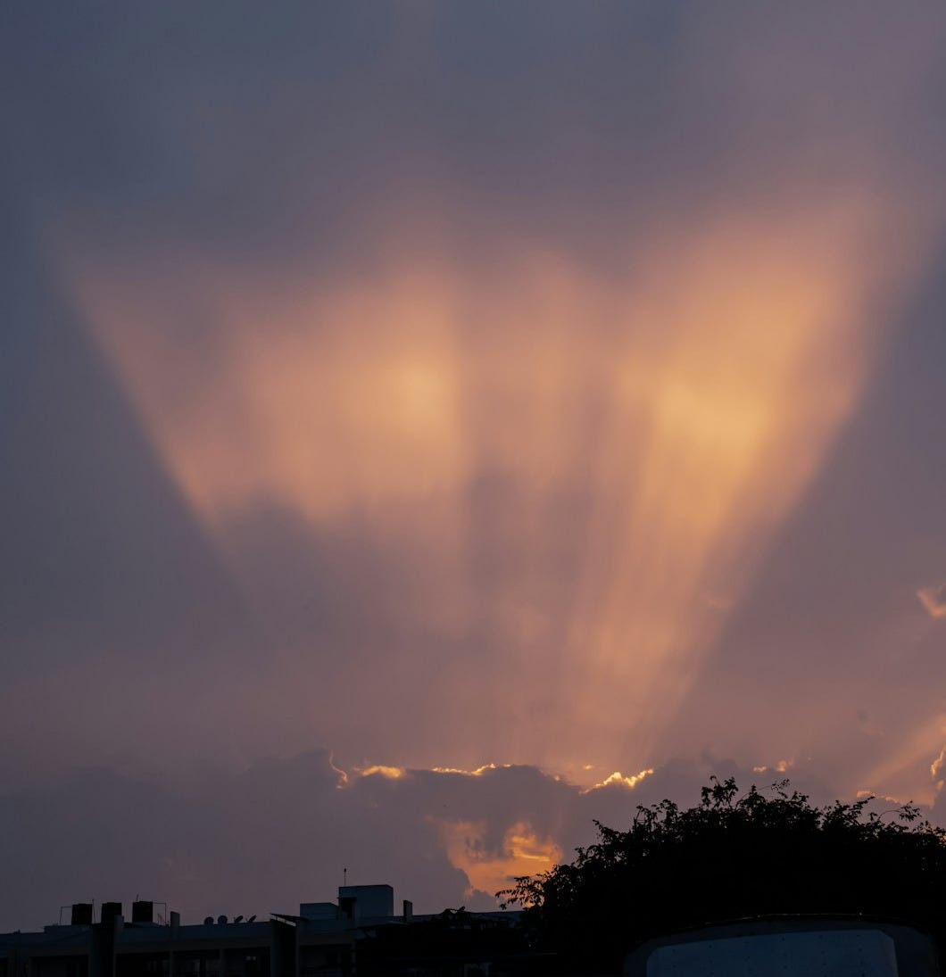 the sun is shining through the clouds in the sky