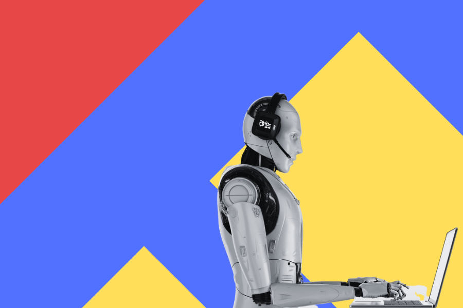Robot sentado escribiendo en una computadora portátil