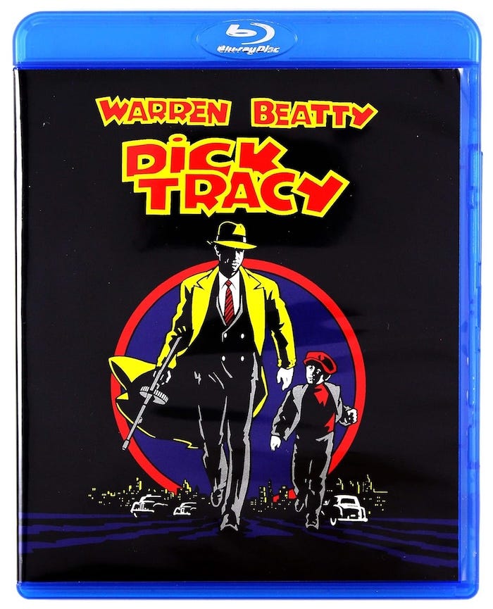 Front cover of the Dick Tracy Blu-ray release from Touchstone, featuring bold comic-style artwork with Dick Tracy and The Kid walking against a red-and-blue city backdrop. Front cover of the Dick Tracy Blu-ray release from Touchstone, featuring bold comic-style artwork with Dick Tracy and The Kid walking against a red-and-blue city backdrop.
