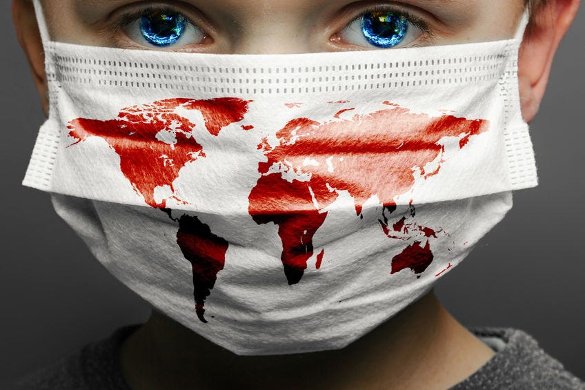 Face of a mask-wearing boy with fear in the eye