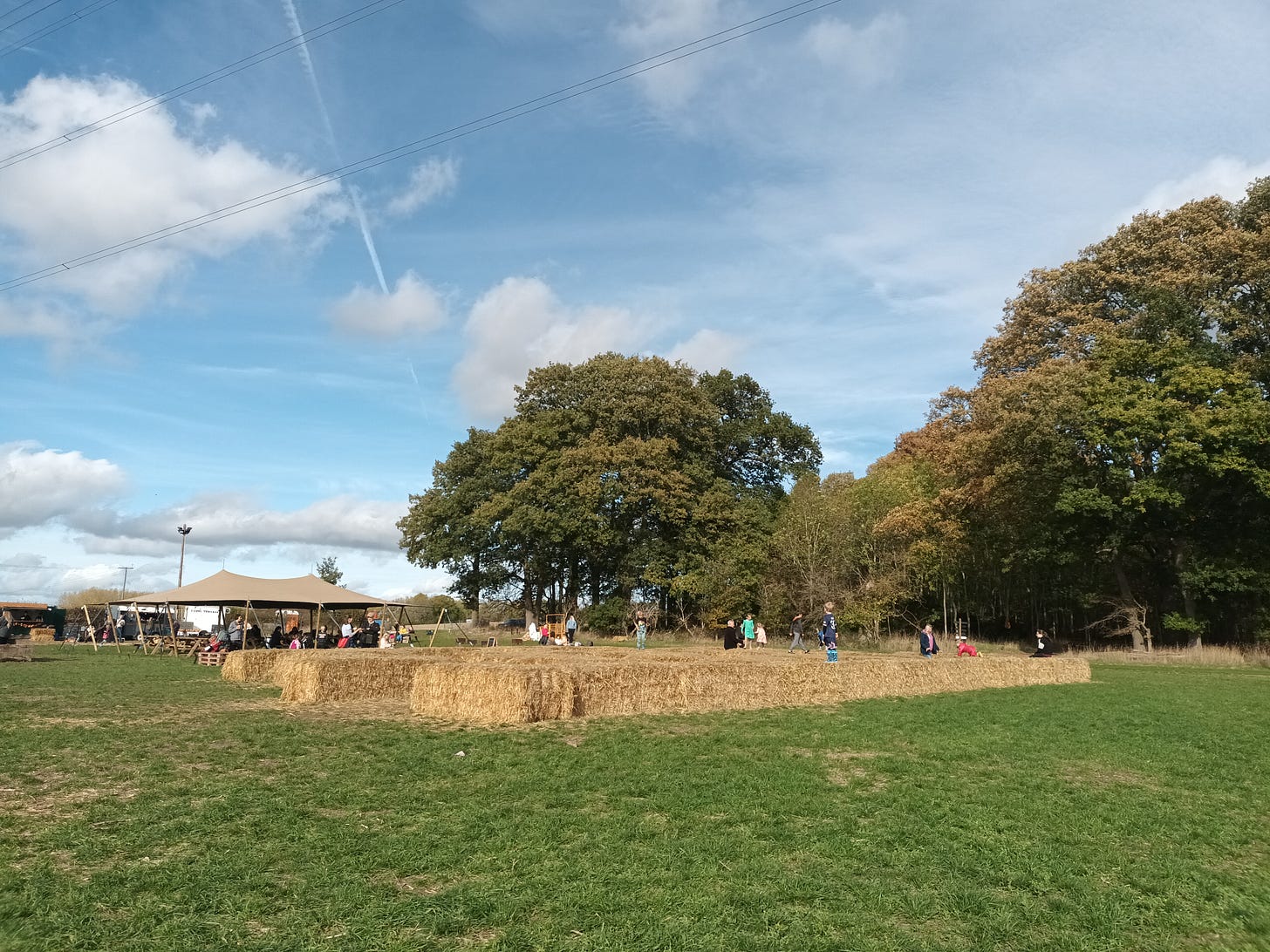 Children playing on a bale maze