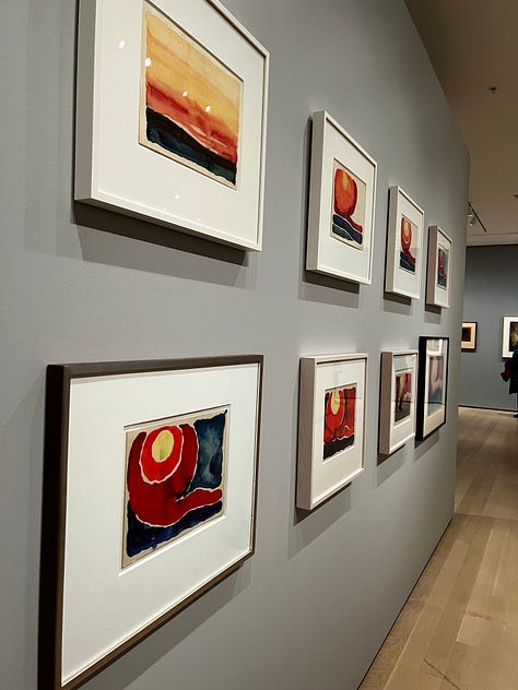 Images from the Georgia O'Keeffe show at the MoMA. Some are works on paper, mostly swirls; others are watercolors of nudes, sunrises, flowers, or rocks.