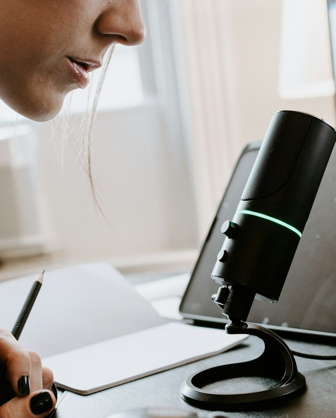 person holding black and green portable speaker