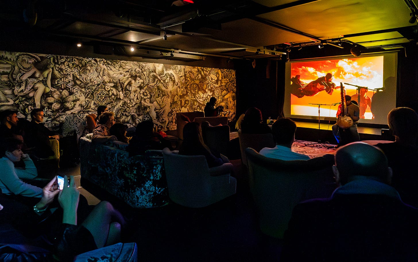 Dark screening room with seated viewers watching projected visuals, showing Minor Attractions’ film programming.