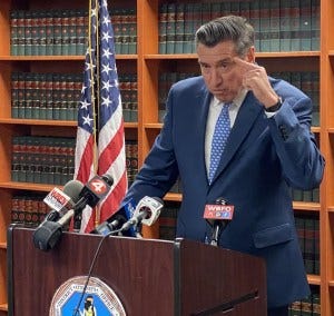 DA John Flynn is comfortable at a podium, but Steve Pigeon claims he got so loose with his words to the press, his case is now severely prejudiced. - Frank Report DA John Flynn is comfortable at a podium, but Steve Pigeon claims he got so loose with his words to the press, his case is now severely prejudiced.