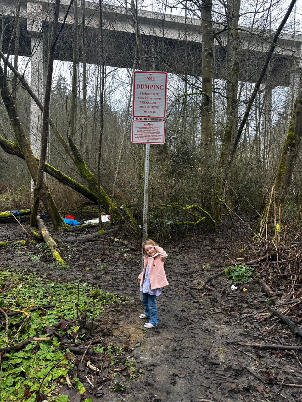 A child standing in front of a sign

Description automatically generated