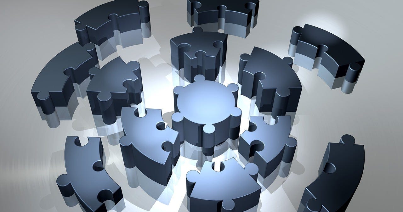 Blocky puzzle pieces with jigsaw-style bumps and indentations, separated out, making an overall circular pattern Blocky puzzle pieces with jigsaw-style bumps and indentations, separated out, making an overall circular pattern
