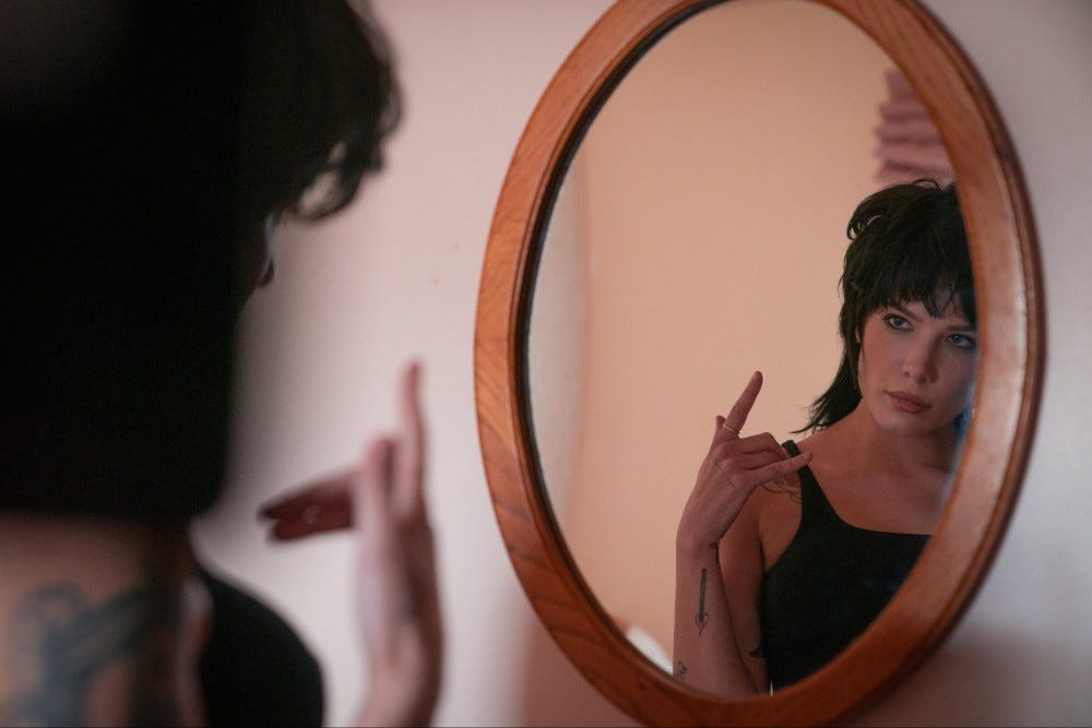 Halsey rockin' out in front of an oval mirror in Americana