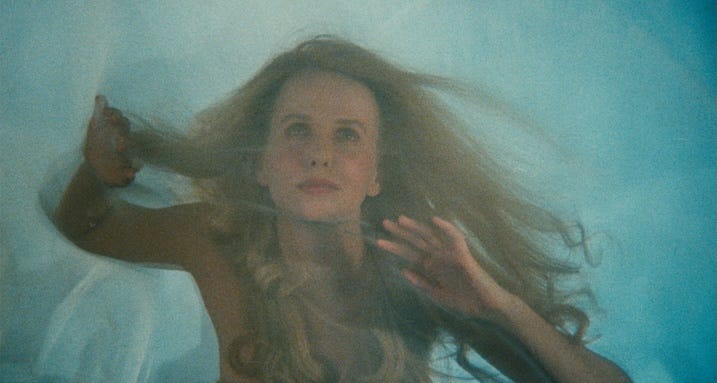 Dream sequence still — Kim Greist floats ethereally through mist in Brazil (1985), part of Sam Lowry’s recurring dream visions.