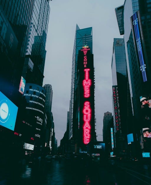 May be an image of skyscraper, Times Square and text that says 'HEL HELPIN ING NG OUR BUILD SAFER ANG INFRASTRUCIA INFRASTRUCT VANCINGINFRAT OVANCIN NGINFR tley " 2020 W o M ME od ហកថ្វី-+ သငဝဟ R GOS ZHANY அள் မသန်ခ'
