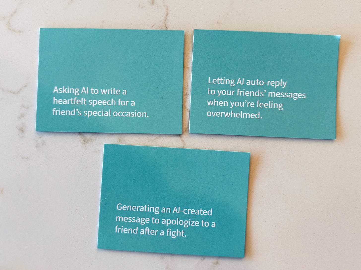 Three teal cards on a marble surface describe AI-assisted social tasks: writing a heartfelt speech for a friend's special occasion, auto-replying to friends' messages when feeling overwhelmed, and tracking special moments to send personalized messages and gifts.