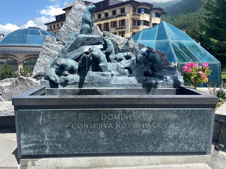 One of the plaques in the Walk of Climb, the Ibex fountain and the Matterhorn Museum, the Marmot fountain, and the Bronze Alphorn, which is pointed directly at the Matterhorn