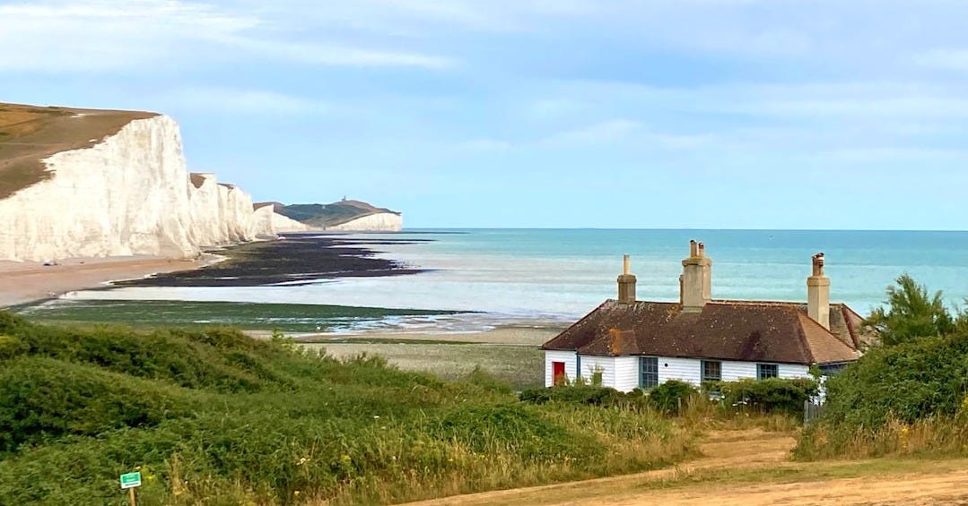 a house on a hill by the water