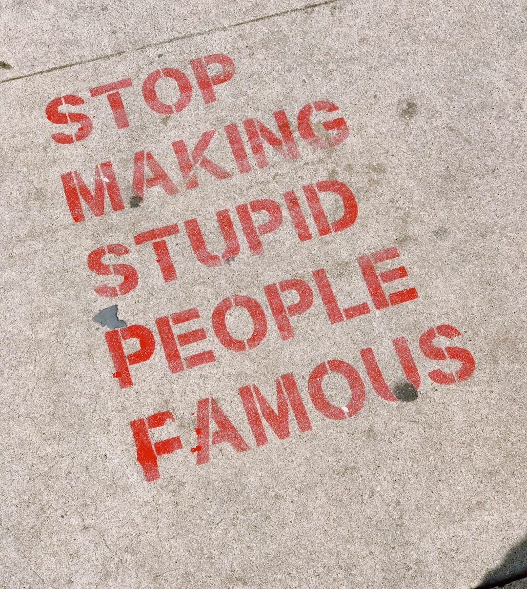 stop making stupid people famous signage