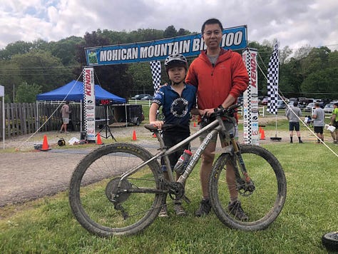 Alex Liu, the youngest person ever to finish the Mohican MTB 100 race, holds his face in his hands during the Mohican Mountain Bike 100 race.