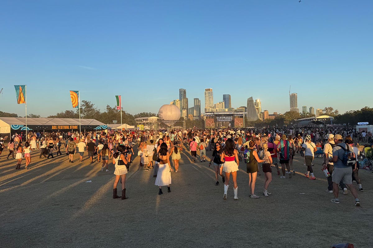Crowd of women at ACL Fest with the city skyline behind them and the main stage in view