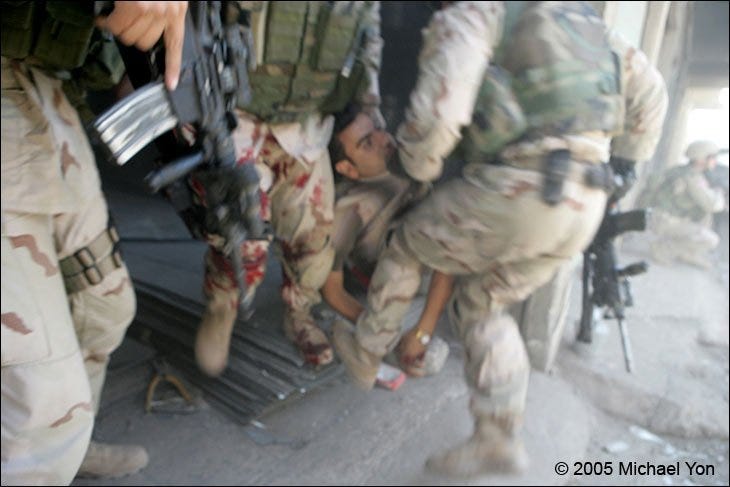 CSM Prosser, his leg drenched in the terrorist’s blood, as 2nd Platoon Alpha Company arrives