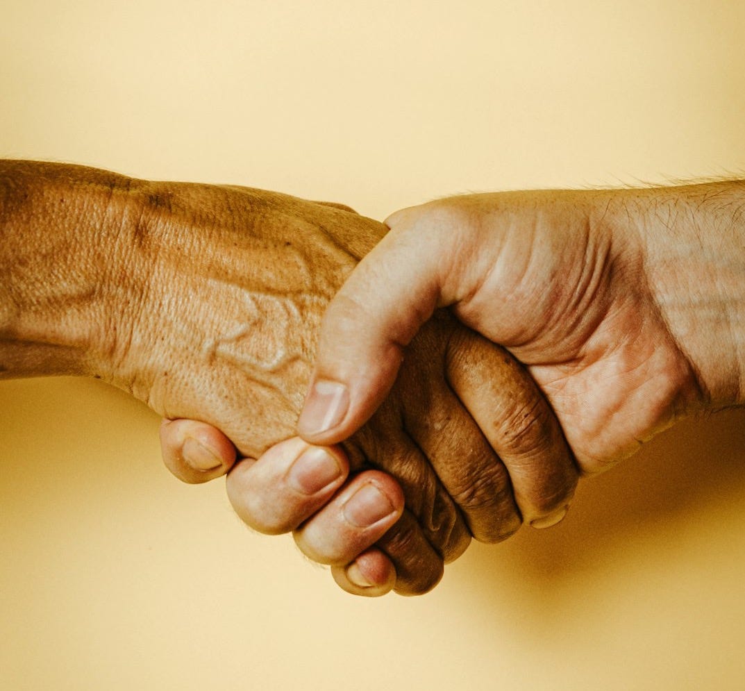 person holding babys hand