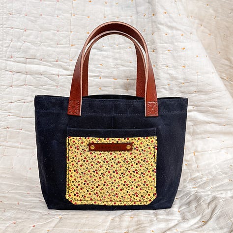 waxed canvas tote with vegetable tanned leather and antique textiles