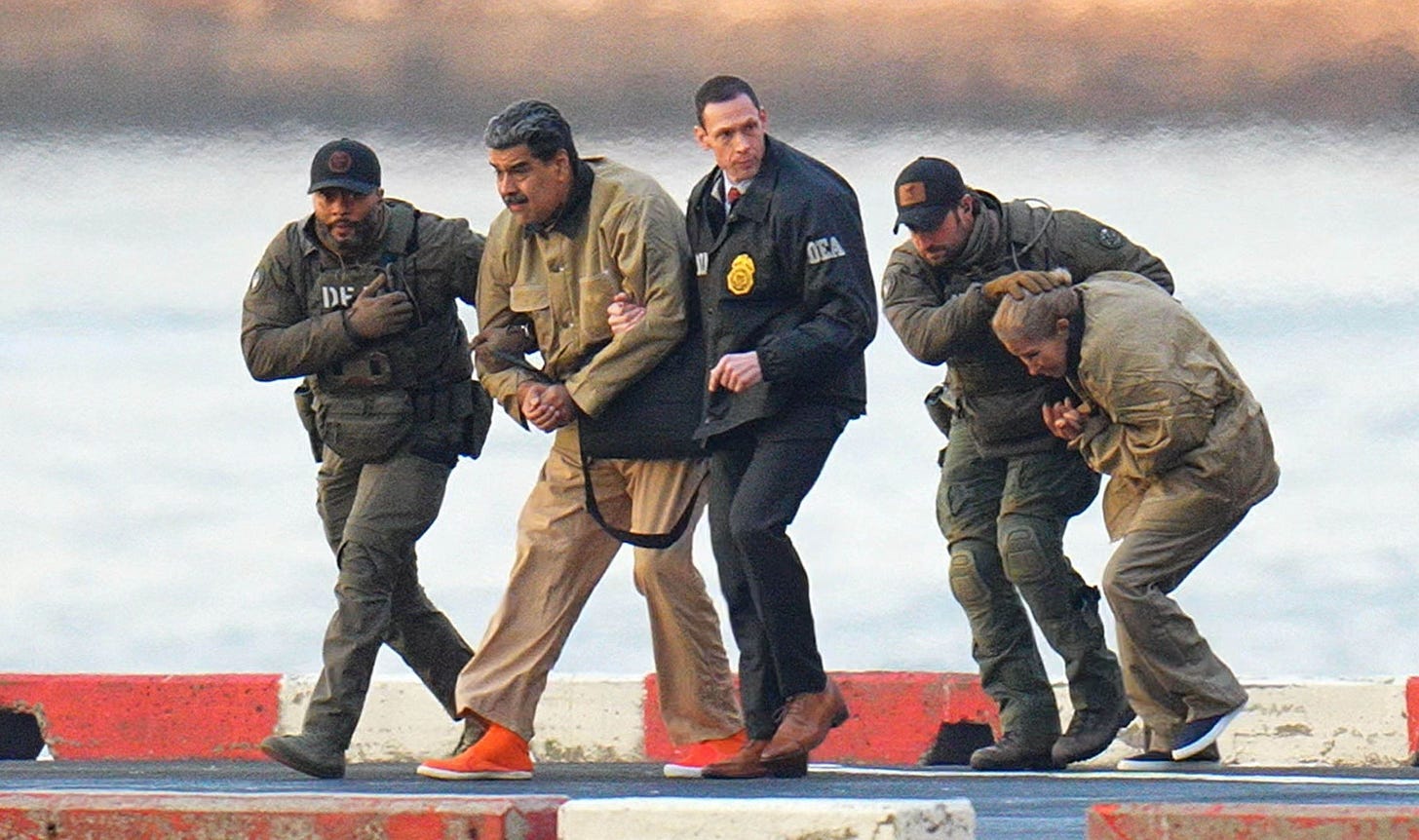 Photo by: XNY/STAR MAX/IPx 2026 1/5/26 Nicolas Maduro and his wife, Cilia Flores, are seen in handcuffs after landing at a Manhattan helipad, escorted by heavily armed Federal agents as they make their way into an armored car en route to a Federal courtho